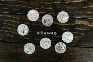 Silver Round Coins on a Brown Wooden Surface