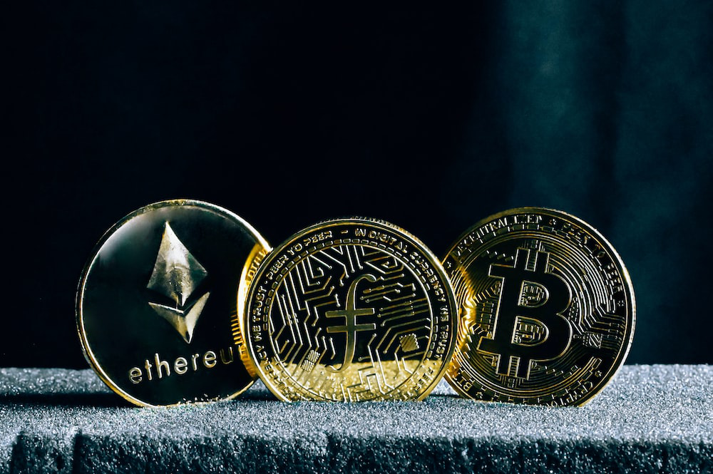 Several cryptocurrency coins depicting cryptocurrency investments