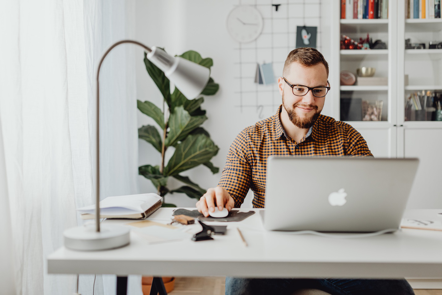 a man sitting and working on his laptop 