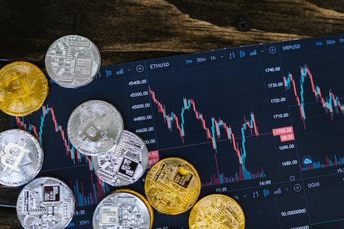 statistical graph on a tablet with crypto-coins placed on it