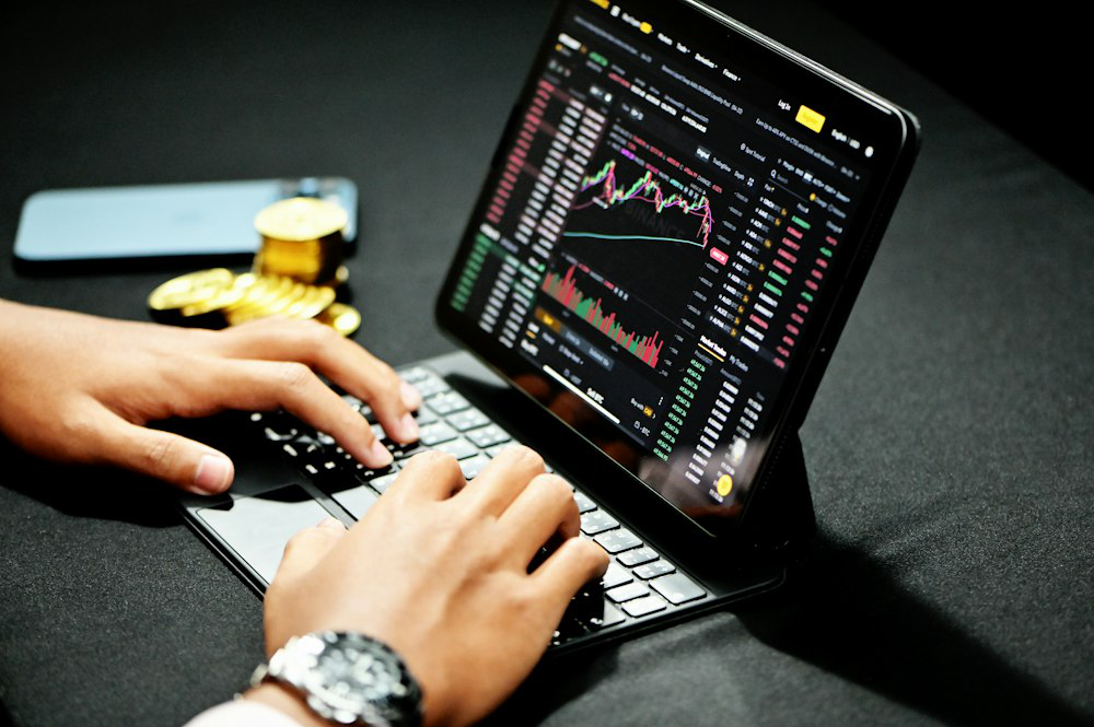 man trading digital assets using a laptop