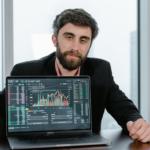 digital asset management consultant using market trends on a laptop for crypto asset allocation
