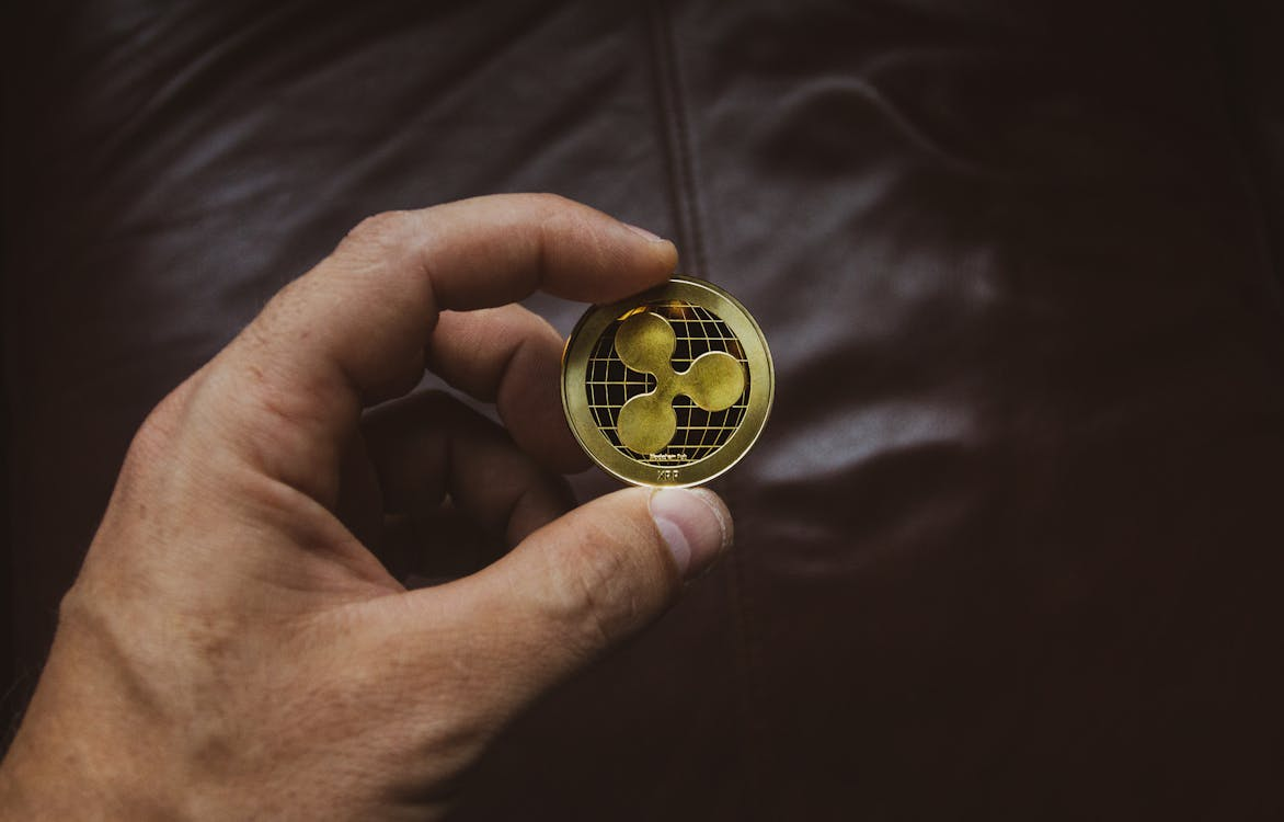 Person holding Ripple coin