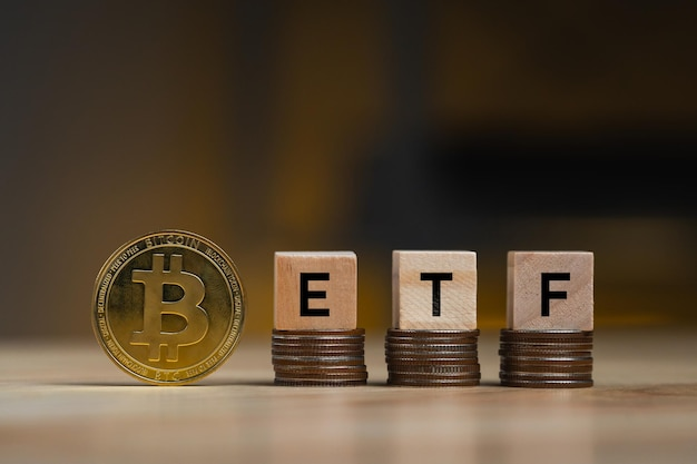 Bitcoin stack with wooden letter blocks reading ‘ETF’ 