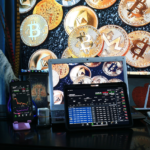 Multiple screens showing cryptocurrency trading charts and various cryptocurrencies.