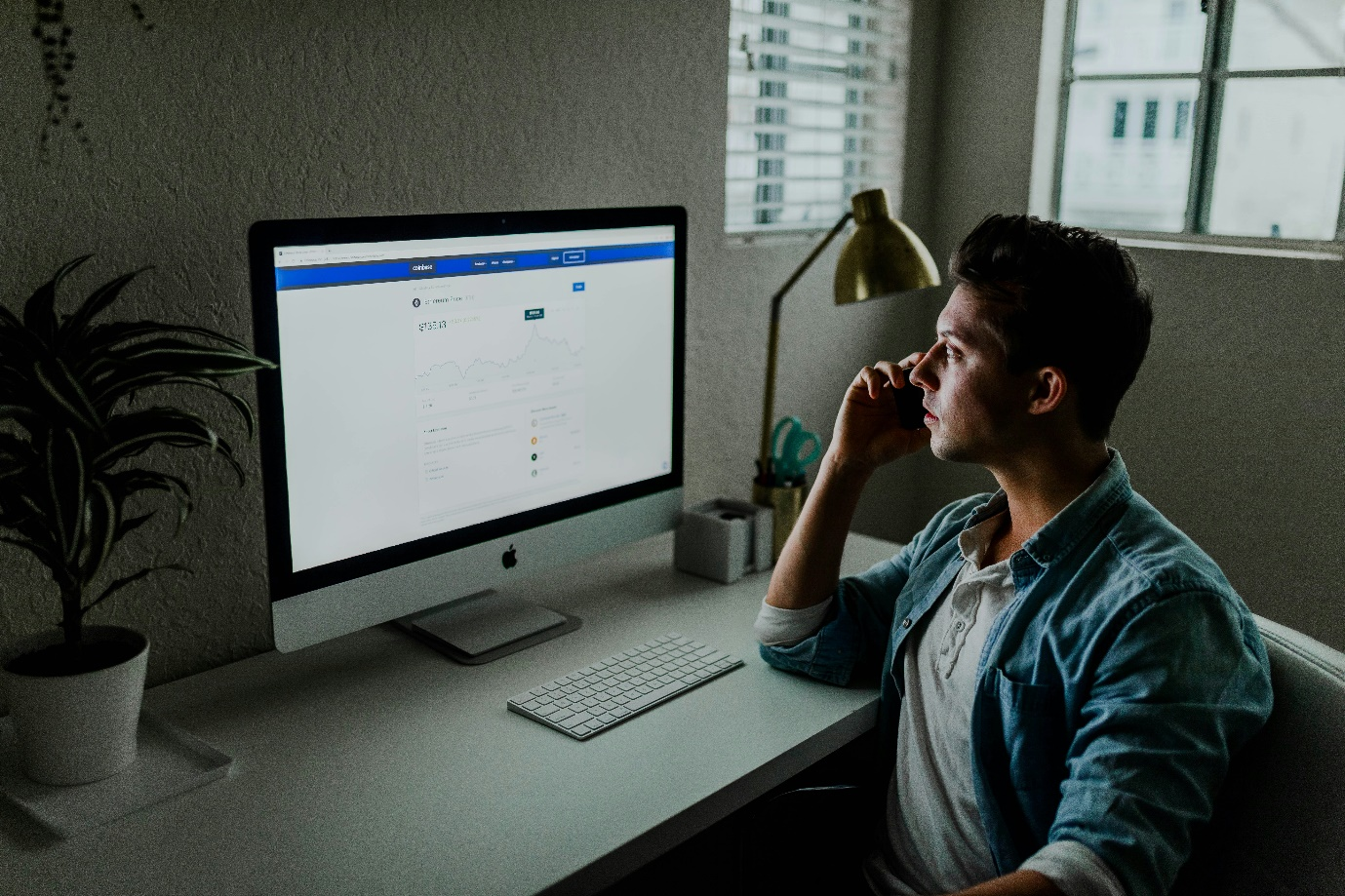 a man facing a computer