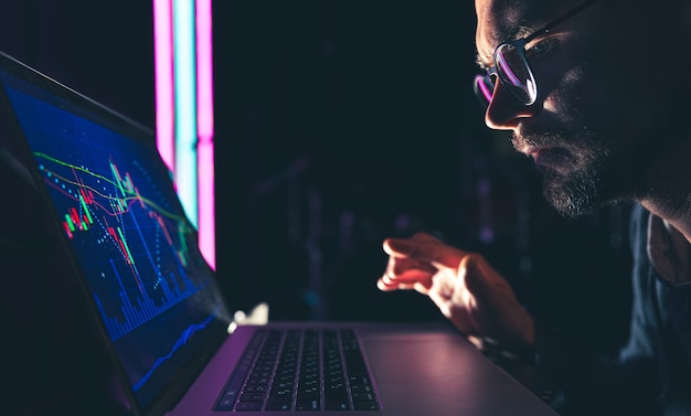 Person analyzing crypto market trends on a laptop.