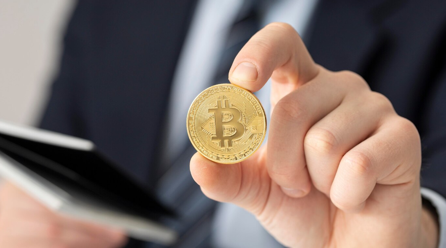 businessman holding a Bitcoin