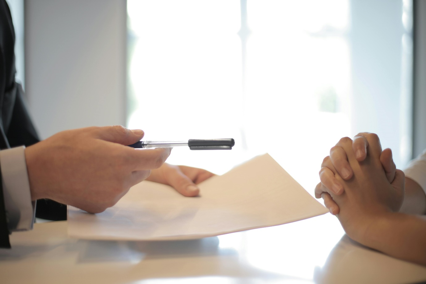 a businessman gives a contract to another person