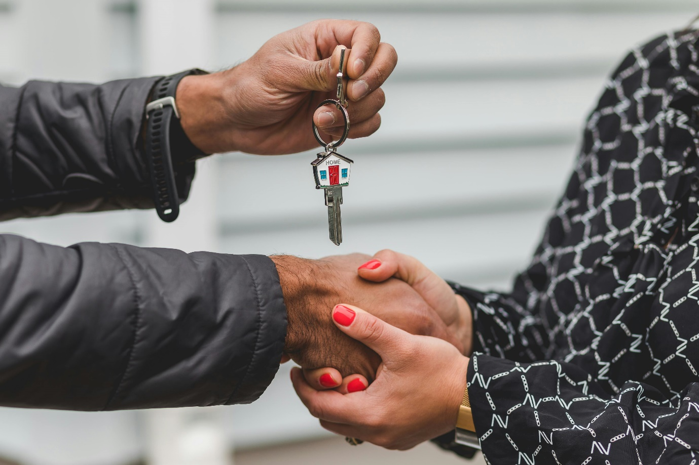 a person holding silver key