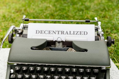 Paper attached to typewriter reading Decentralized