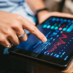 a man checking market data on a tablet