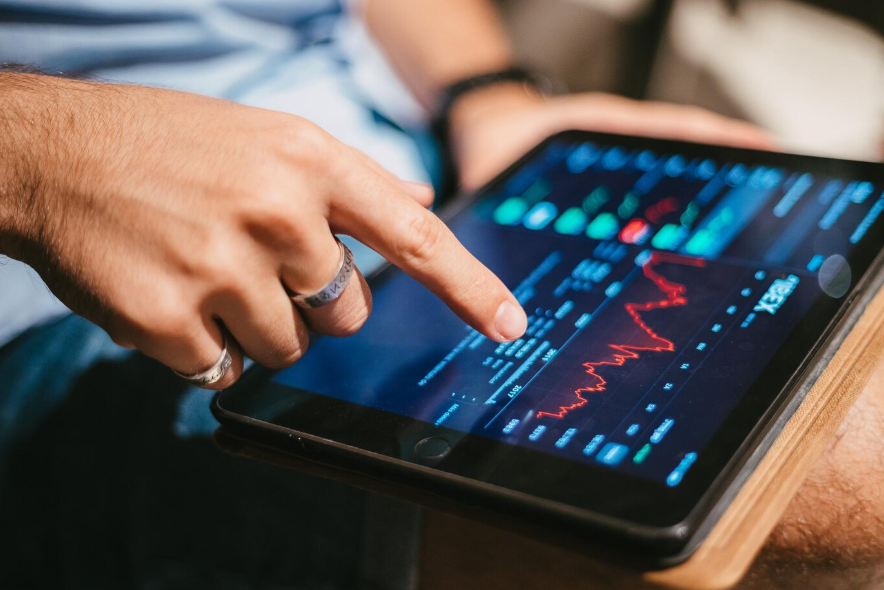 a man checking market data on a tablet