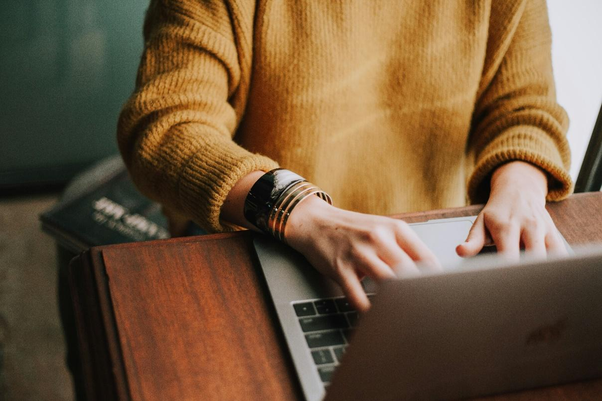 A person using a computer to access digital assets.