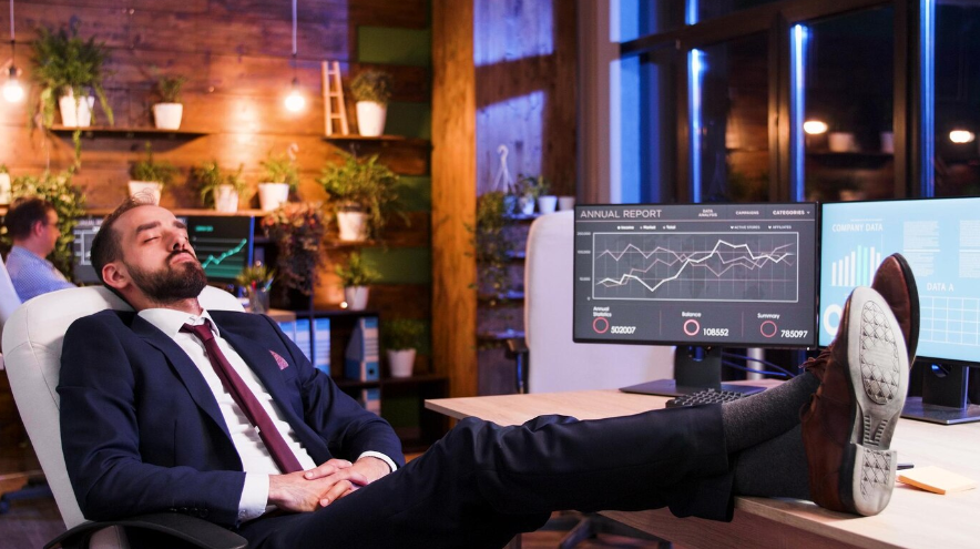 a businessman sleeping with his feet on the table