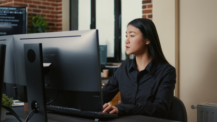 a programmer focused on writing code while sitting at desk