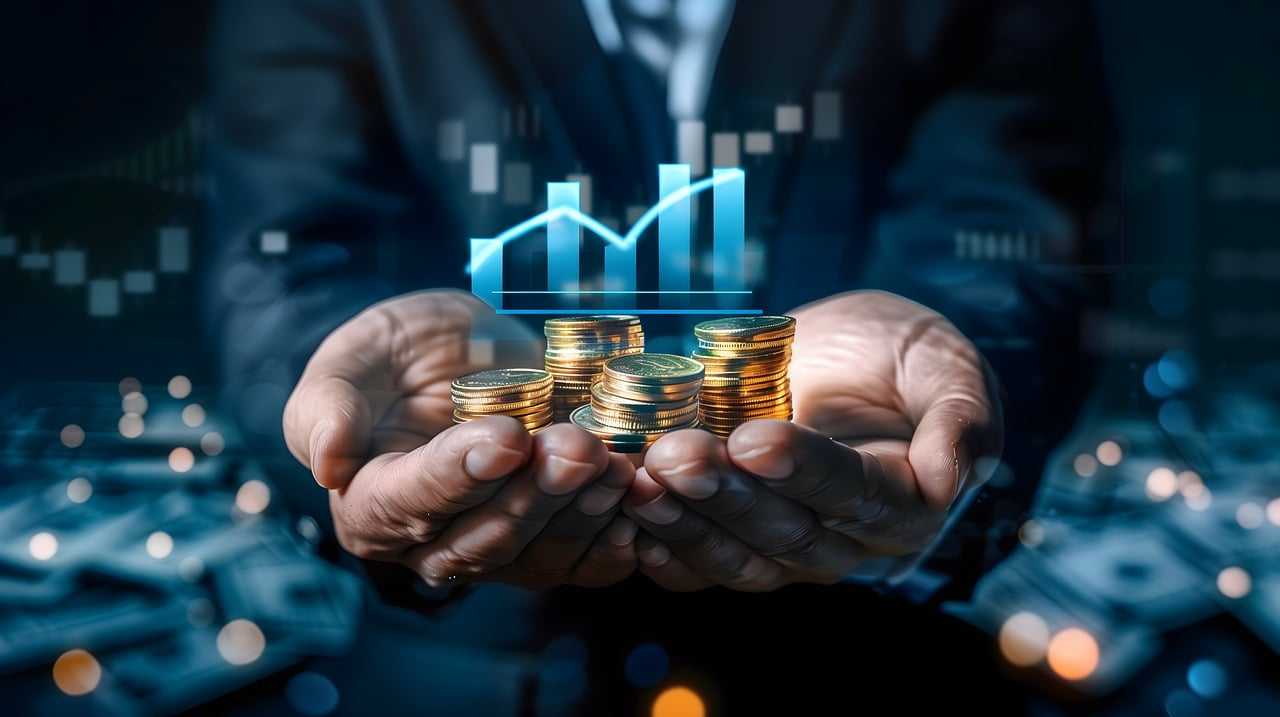 A person holding stacks of coins with a rising graph representing digital investment growth.