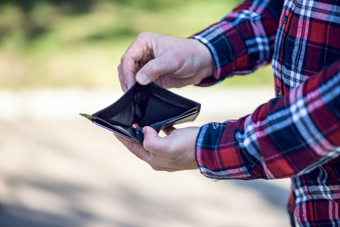 A person's hands holding an empty wallet