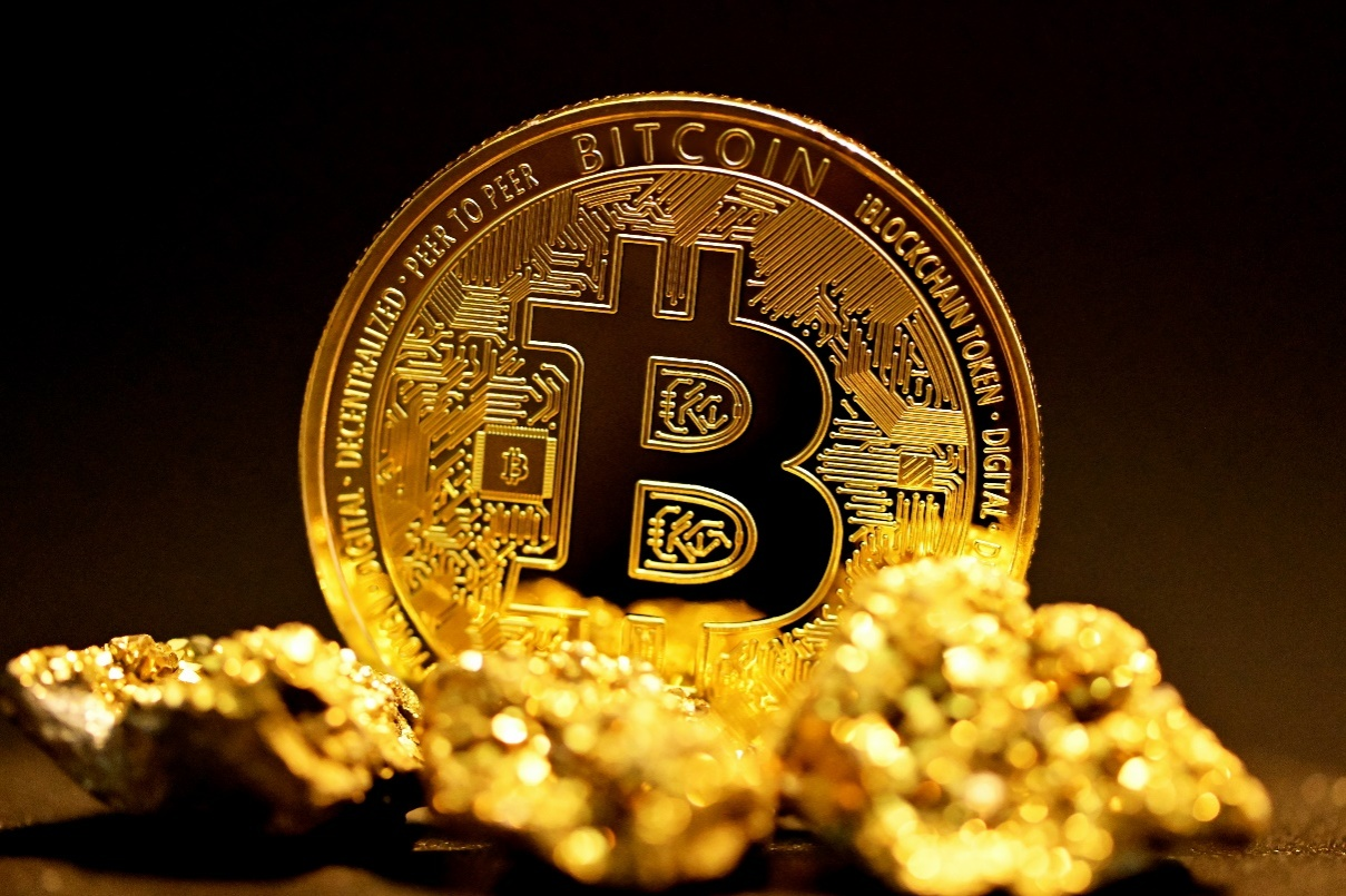 Bitcoin and a gold nugget.