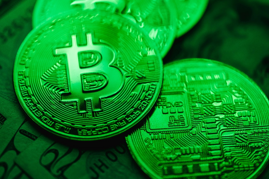 A collection of green Bitcoin coins.