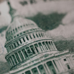 A close-up image of a US dollar bill, focusing on the Capitol Building.