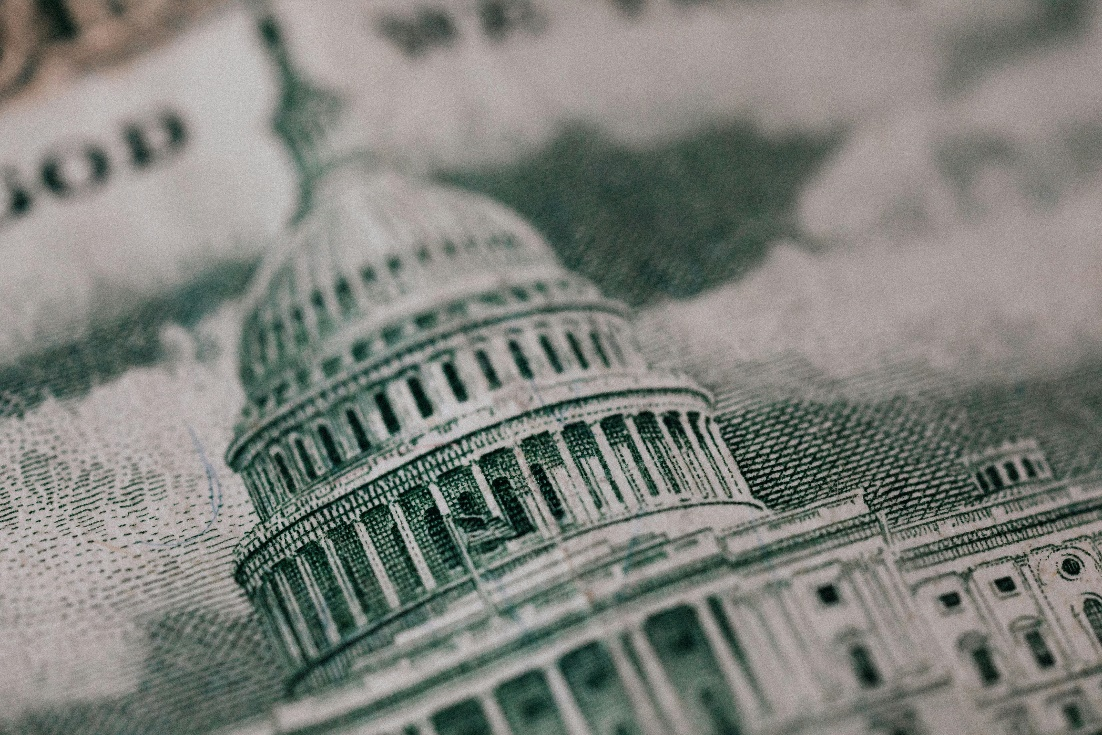 A close-up image of a US dollar bill, focusing on the Capitol Building.