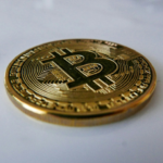 A close-up image of a physical Bitcoin coin.