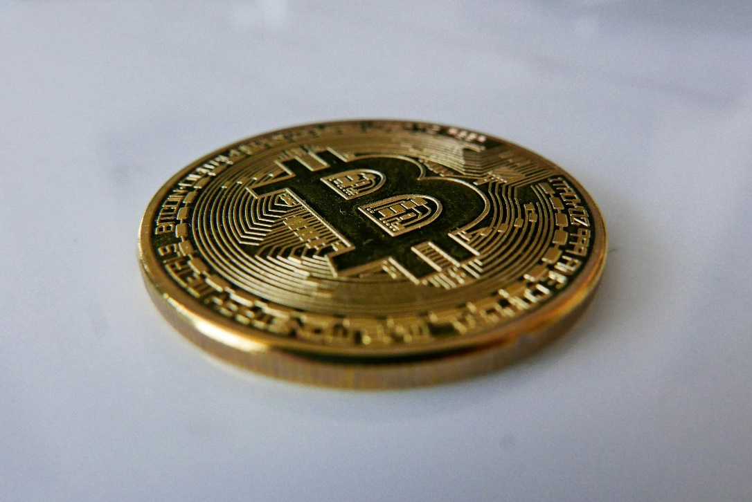 A close-up image of a physical Bitcoin coin.