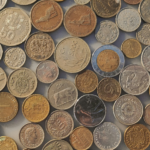 A collection of coins from different countries, representing the diversity of global currencies.