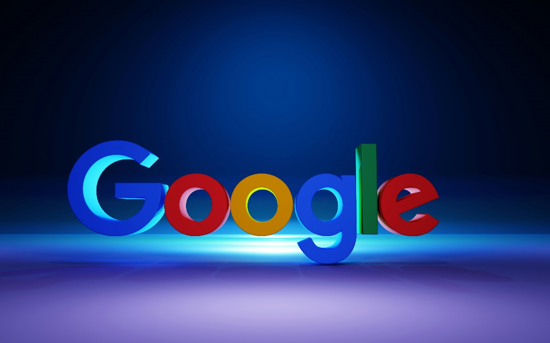 The Google logo illuminated on a dark blue background.