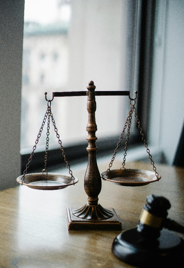 A set of scales of justice resting on a wooden table.