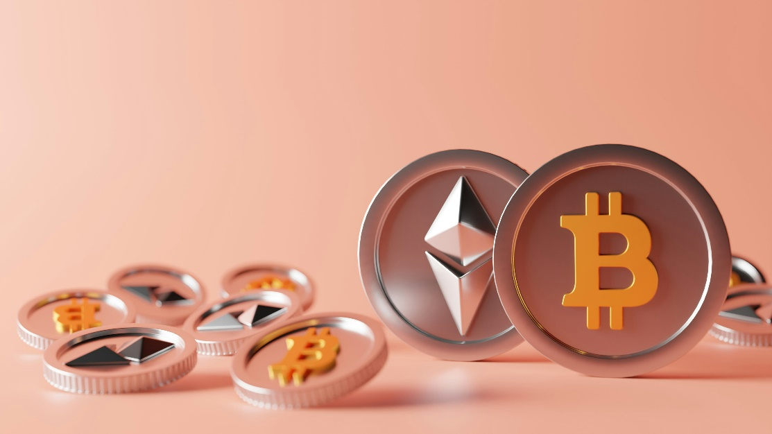 A 3D-rendered image of several silver and gold Bitcoin and Ethereum coins scattered