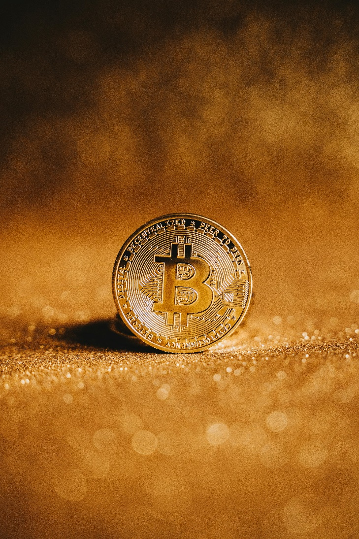 kenson Investments | Coinbase Introduces Bitcoin Yield Fund for Global Institutions. Close-up image of a physical Bitcoin coin symbolizing institutional crypto investment