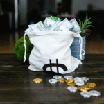 money on a tote bags and coins on the table