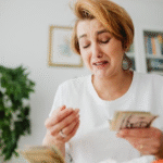 woman counting money and crying