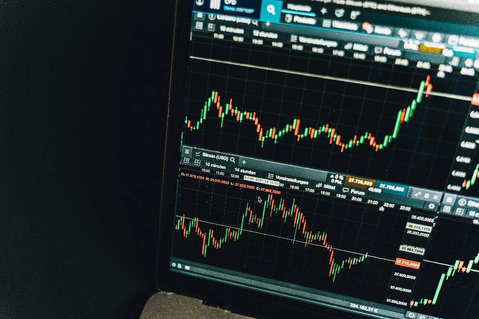 Digital chart on black screen displaying asset performance metrics