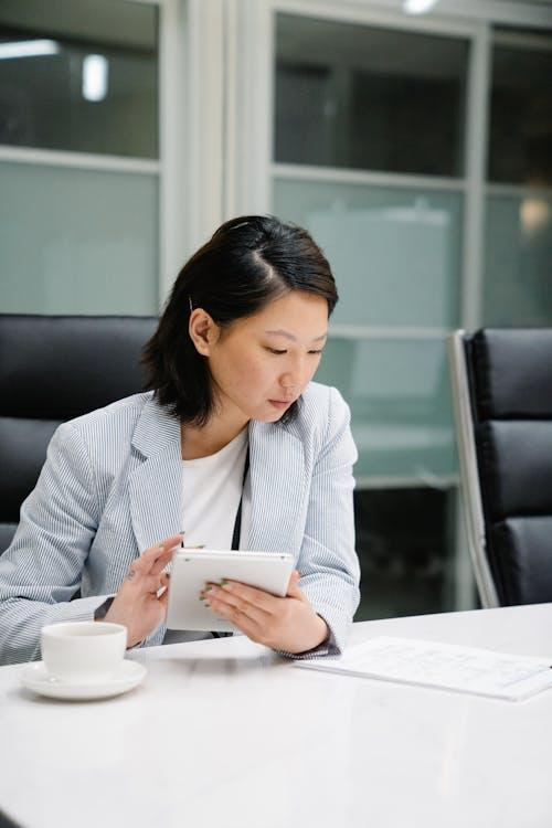 woman with tablet and documents