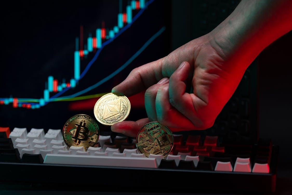 hand holding cryptocurrency coins with graph background