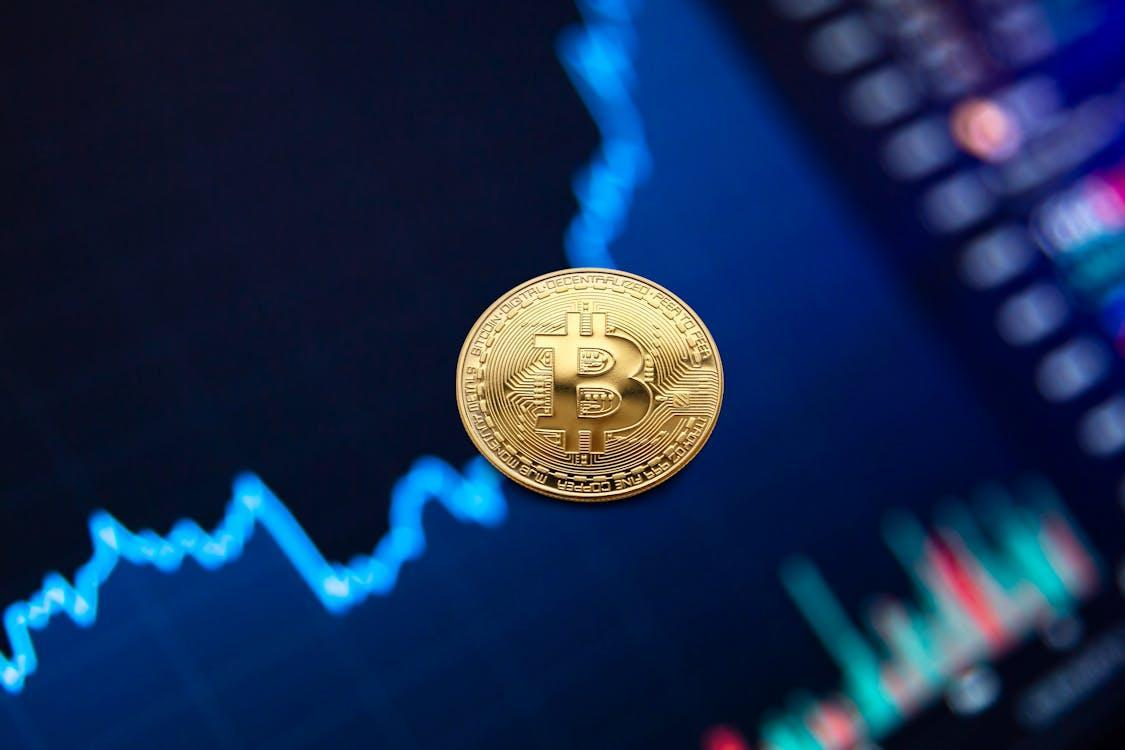 gold bitcoin coin on background of growth chart