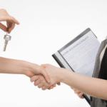 a broker handing the key to her client