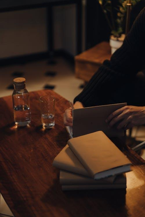 kenson Investments | Tokenized Asset Structures: Managing Security Considerations in 2025 person in black long sleeve shirt holding white book