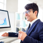 man in formal dressing looking at a computer in the office
