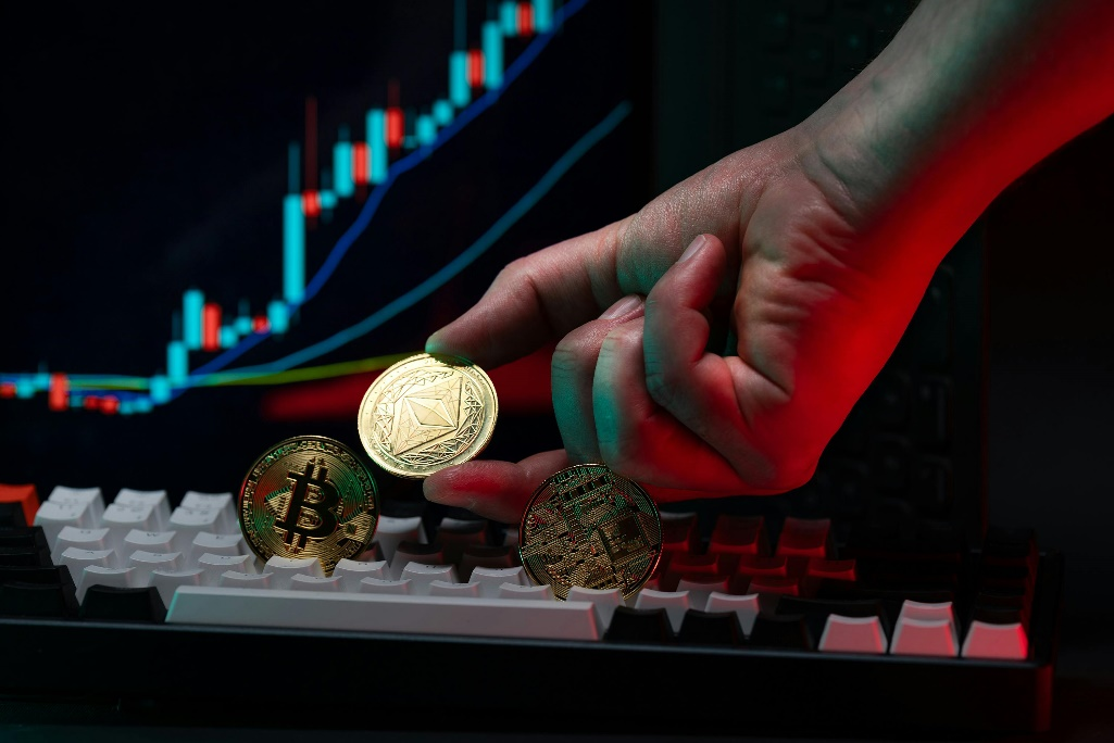 Hand holding cryptocurrency coins.