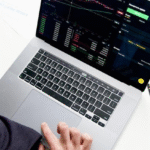 person using macbook pro on white table