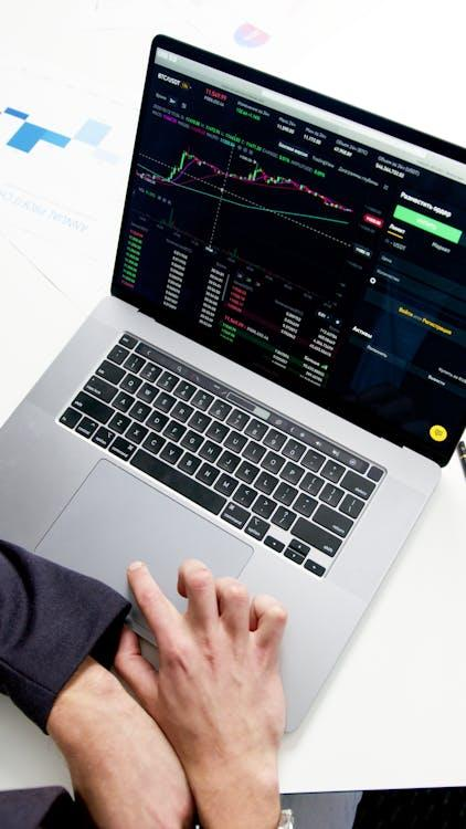 kenson Investments | Bitcoin Crosses $100K—But Can It Keep the Crown as Altcoins Lag Behind? person using macbook pro on white table