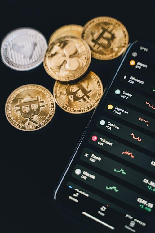 kenson Investments | Tokenized Equities: Expanding Access to Equity Markets Through Blockchain mobile phone beside bitcoins