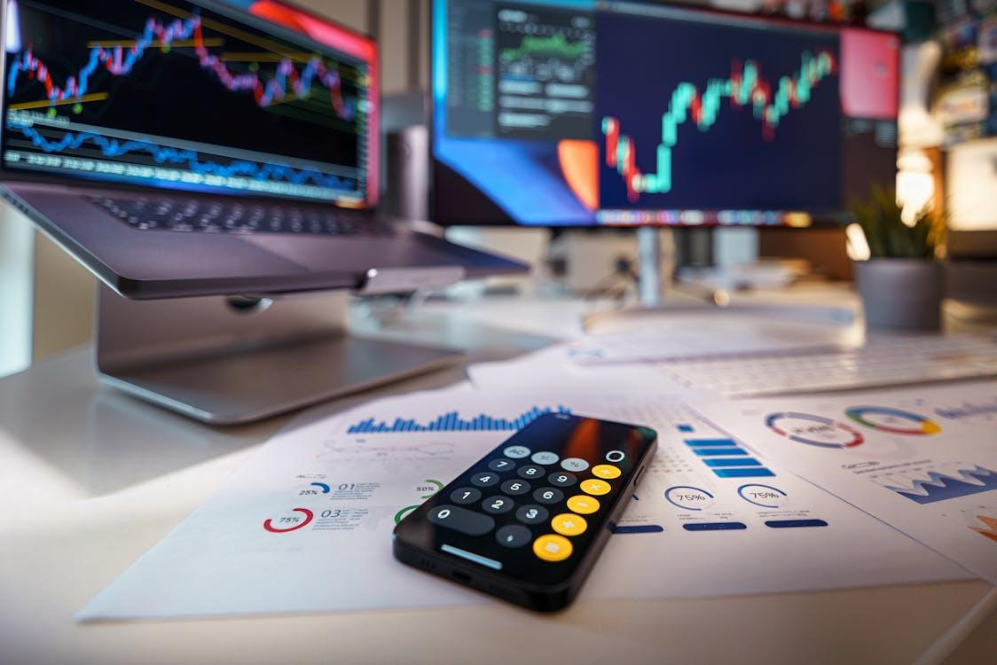 kenson Investments | Bitcoin’s Not Done Yet: Analysts See More Upside as Coinbase Rockets 24% currencies and finance stock exchange calculator on the table