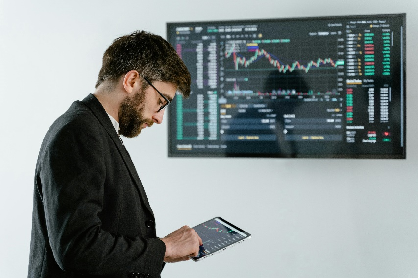 Business professional analyzing data on a digital screen.