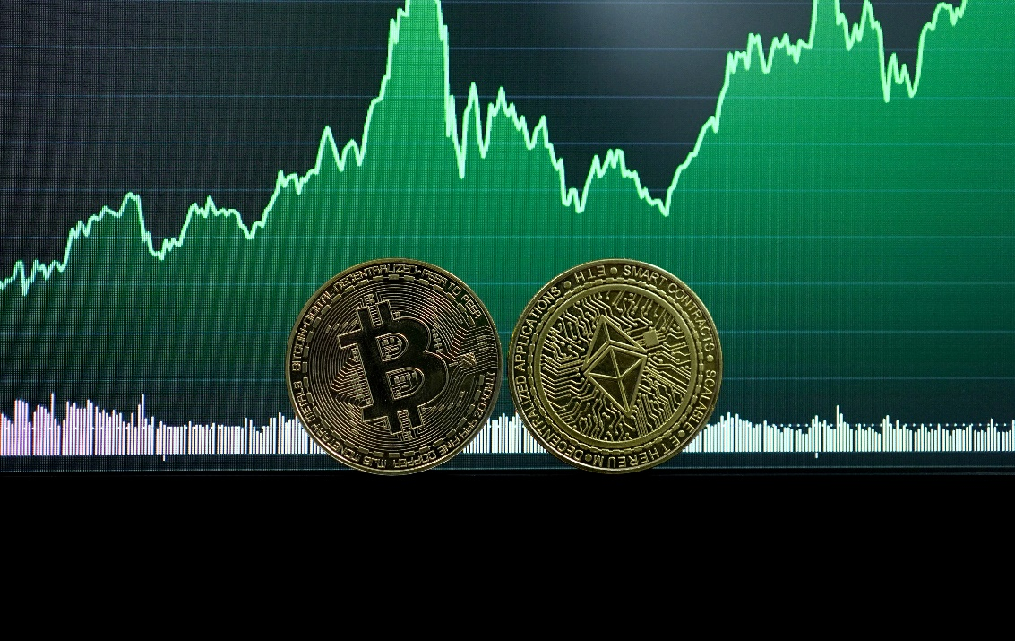 kenson Investments | Fidelity Digital Assets Report Highlights Institutional Interest A person analyzing cryptocurrency data on a laptop, representing institutional interest in digital assets and market trends.