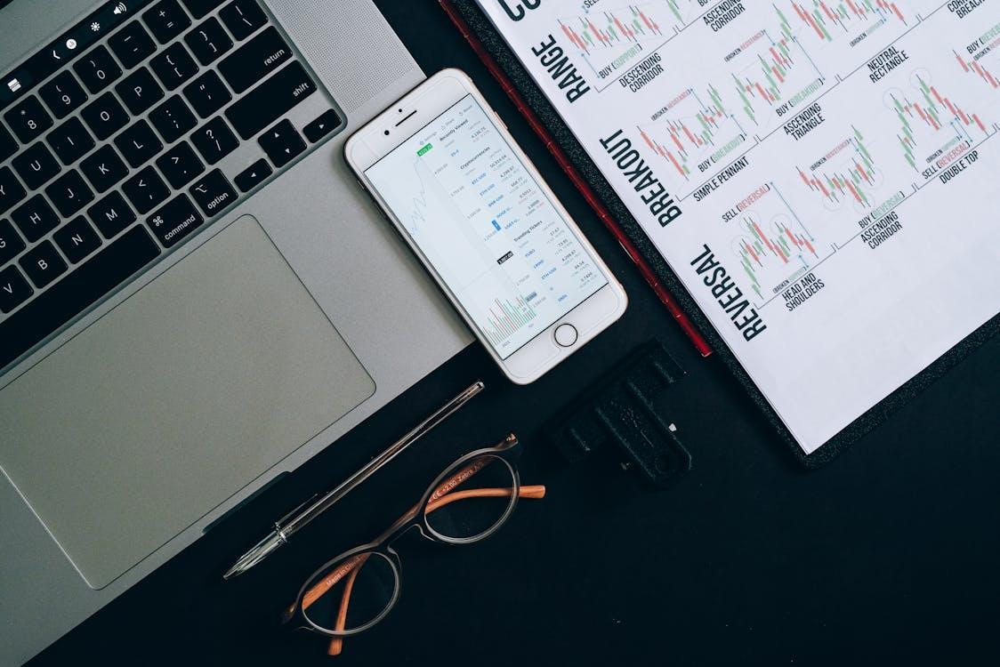 kenson Investments | Institutional Liquidity Pools – Expanding Infrastructure for Digital Asset Strategies smartphone on the table